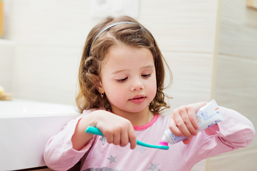 Ferndale child putting toothpaste on a toothbrush Ferndale child putting toothpaste on a toothbrush